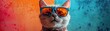 © tonstock - Funny cat wearing stylish blue sunglasses posing against a colorful red and blue background, adding a touch of coolness and charm.