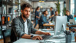 © Катерина Євтехова - featuring a tech-savvy man at his computer in a creative office, with moving colleagues in the background representing collaboration and connectivity, ideal for themes of technolog