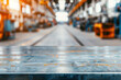 © tonstock - Empty metal table in an industrial warehouse with blurred background. Concept of manufacturing, industrial production, and factory setting.