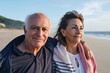 © Westend61 - Smiling senior man and woman at beach