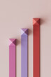 © Westend61 - 3D render of multi colored bar graph over pink background