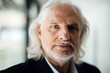 © Westend61 - Confident senior businessman with long white hair at office