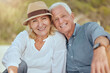 © Maass/peopleimages.com - Portrait, outdoor and senior couple with love, smile and retirement with vacation, getaway trip and travel. Face, old man and mature woman in park, holiday and romance with care, happiness and break
