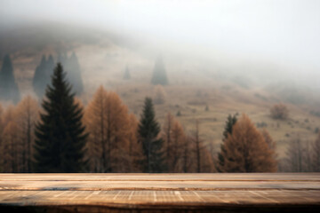 Poster - Empty wooden tabletop with a blurred autumn forest and misty mountains as background