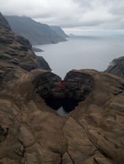 Poster - Dramatic heart-shaped rock formation overlooking a misty fjord