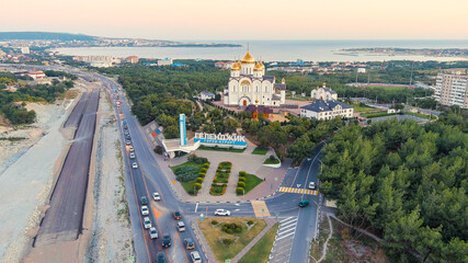 Wall Mural - Gelendzhik, Russia. Cathedral of St. Andrew. The text along the M4-Don Highway is translated: Glory to Russia, Kuban-Pearl of Russia. Gelenzhik-City Resort. Sunset, Aerial View