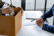© mojo_cp - Resignation concept.Businessmen packing Stuff with cardboard box for quit a job