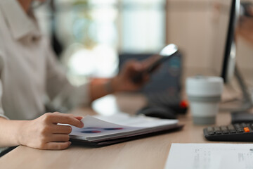 Wall Mural - Businesswoman working with data spreadsheet documents at workplace