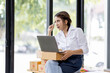 © David - Portrait business woman smile and use laptop checking information on parcel shipping box before send to customer. Entrepreneur small business working at home. SME business online marketing.