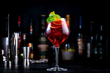 Wall Mural - Summer sangria cocktail drink with red wine, peach, plum, orange, lime and ice. Black background