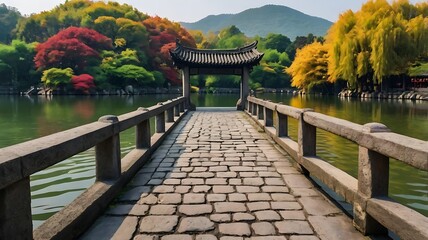 Wall Mural - shows a stone arch bridge over a pond with a stone path l