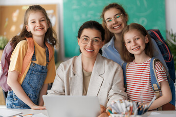 Wall Mural - Happy kids and teacher at school