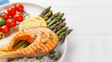 Wall Mural - Grilled salmon steak over grilled asparagus, a delicious and healthy meal