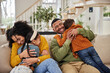 © peopleimages.com - Happy, parents and kids with hug on sofa for appreciation, gratitude and safety in family at home. Mother, father and smile with affection of children in living room for connection, support and love
