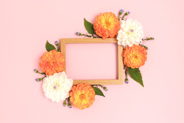Wall Mural - flower border frame made of dahlia on a pink background. springtime holidays concept with copy space