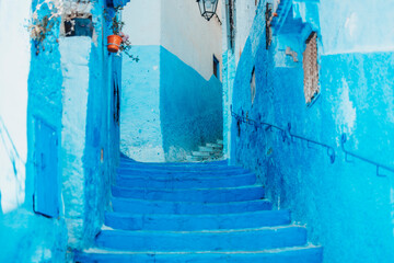 The blue streets and doors of Chefchaouen, Morocco, create a mesmerizing, serene atmosphere. Painted in various shades of blue, the narrow alleys and vibrant doorways reflect the sky and sea, 