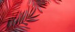 © vxnaghiyev - Tropical vacation concept featuring red palm fronds set against a coral background with copy space image