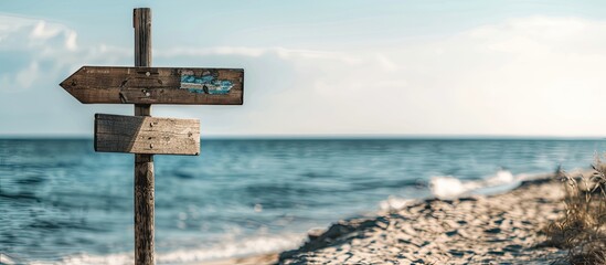 Poster - Scenic beach sign against a backdrop of the sea perfect for travel themed copy space image