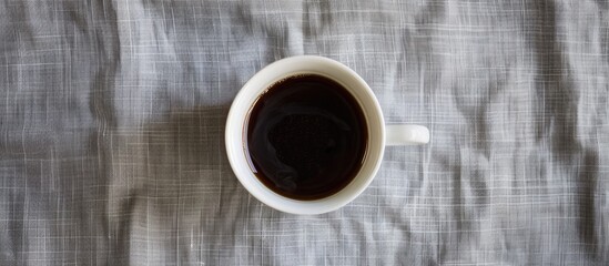 Aufkleber - A top down view of a hot cup of black coffee in a white mug on a gray tablecloth serving as a copy space image