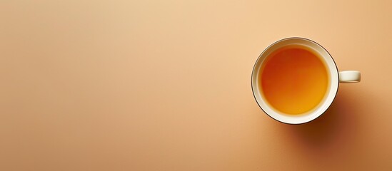 Aufkleber - A cup of tea placed on a light brown background with copy space image