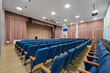© FedotovAnatoly - Empty auditorium hall. Conference room interior with a stage and blue chairs