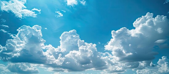 Fototapete - Scenic view of a blue sky with fluffy white clouds ideal for adding text or graphics with copy space image