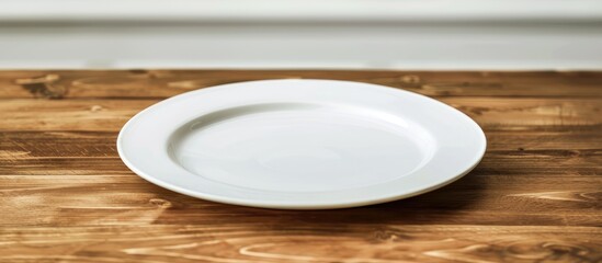 Poster - A wooden table displaying a white plate with ample copy space image