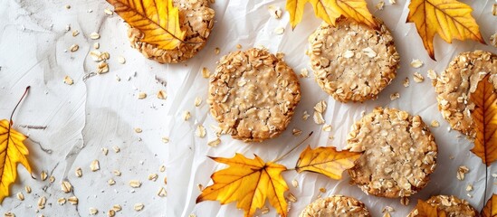 Aufkleber - Autumn themed oat cookies on a light background with parchment decorated with yellow leaves creating an enticing fall themed copy space image