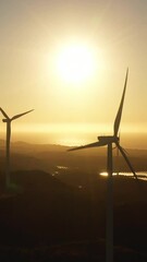 Wall Mural - Aerial drone of Wind turbines for electric power production on the seashore at sunset. Wind power plant. Ecological landscape. Philippines.