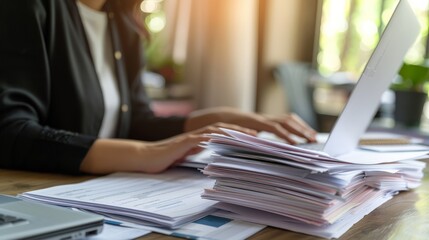 Aufkleber - Professional woman typing on a laptop with tax forms and documents on a cluttered desk. Tax season and financial management concept.
