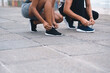 © peopleimages.com - People, hands and tie shoes for running, fitness or getting ready for workout, hiking or walking in city. Closeup, athletes or runners tying footwear for trekking, health or cardio exercise outdoors