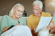 © Maass/peopleimages.com - Mature couple, home and savings with paperwork for house finance, budget and retirement plan. People, relationship and sofa in living room with documents or contract for life policy or insurance