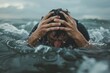 © Milos - In this image, a man holds his head in his hands, submerged in stormy sea waves, suggesting a deep sense of despair and struggle, reflecting emotional and physical hardship.