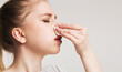 © Prostock-studio - High blood pressure. Young woman suffering from nose bleeding, stop blood with tissue, free space