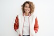 © Markus Schröder - Portrait of a grinning woman in her 40s sporting a stylish varsity jacket over white background