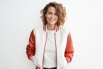 Wall Mural - Portrait of a grinning woman in her 40s sporting a stylish varsity jacket over white background