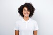 © Markus Schröder - Portrait of a blissful afro-american woman in her 20s wearing a sporty polo shirt isolated on white background