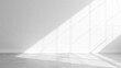 © Hanna - White empty studio room with sunlight shadows from window and concrete floor with white brick wall background, empty white space room mock up with sunlight, white room space interior