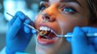 © Vilaysack - Woman undergoing a dental check-up, with dentist using tools for examination, highlighting oral health care in a clinical setting.