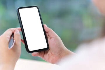 Wall Mural - mockup image of woman hands holding smartphone with blank screen for advertise text.