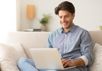 Poster - Remote Job. Man Working On Laptop Sitting On Sofa At Home. Empty Space For Text