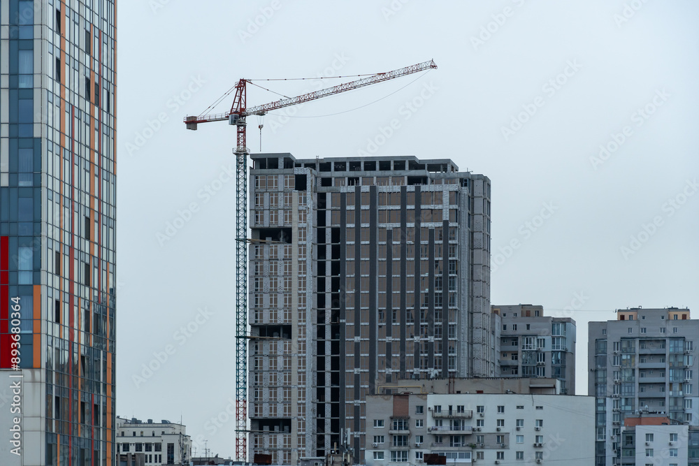Industrial construction cranes work above new modern building ...