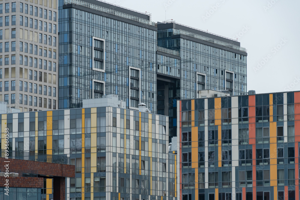 Industrial construction cranes work above new modern building ...