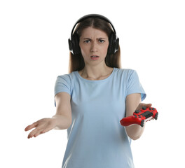 Wall Mural - Disappointed woman in headphones with controller on white background