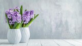 Purple hyacinths in vase on white wooden surface Focus on flowers Space for text