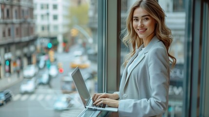 Poster - A woman is sitting in front of a window, typing on a laptop