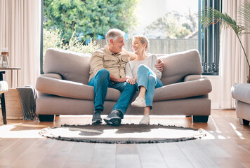 Poster - Mature, couple and relax with love on sofa with connection or support, embrace and affection with care for bonding. Senior, man and woman on couch for lounge on retirement, happy and family home.