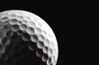 © Mark G - A studio close-up photo white golf ball against a black background with shadows and soft highlights. Space for copy. Golf and leisure concept.