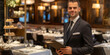 © Andres Mejia - Restaurant manager holding menu and smiling in upscale restaurant