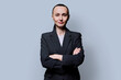 © Valerii Honcharuk - Portrait of serious business 30s woman with crossed arms on grey background